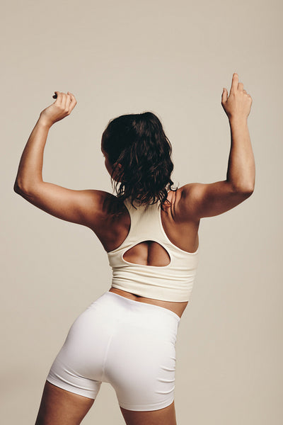 Young female athlete improving her strength and flexibility in a workout