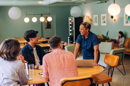 Young professionals engaged in a vibrant discussion at a modern workspace