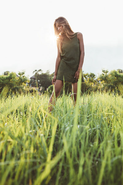Beautiful young lady walking through the meadow