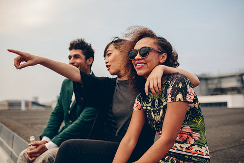 Friends sitting on rooftop and enjoying the view