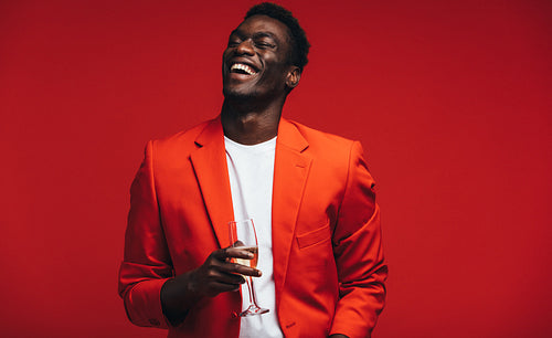 Smiling young guy having champagne