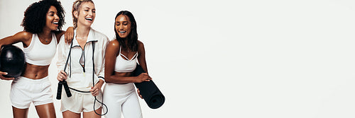 Group of women in sportswear on panoramic white background