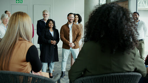Happy colleagues applauding in meeting