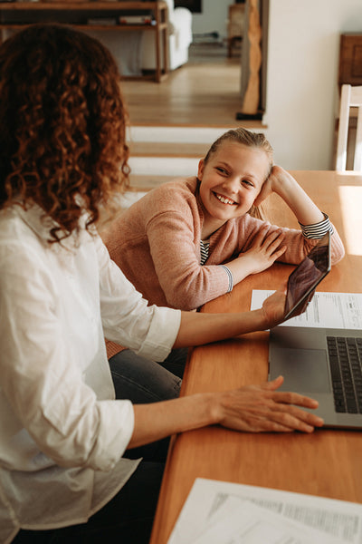Woman talking with her daughter while working at home