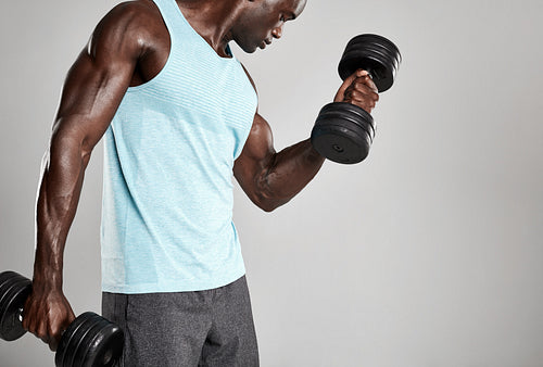 Young man exercising with hand weights