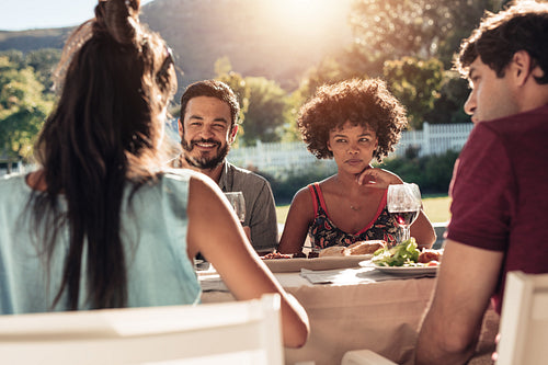 Group of people having alfresco meal