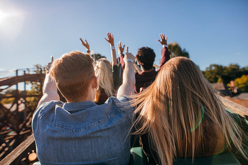 Young people on a thrilling roller coaster ride