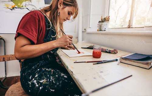 Young woman painting in her studio