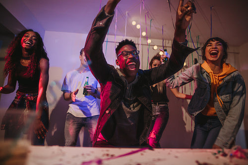 Young group of friends having fun at a house party