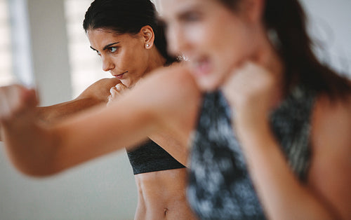 Women working out at gym with focus