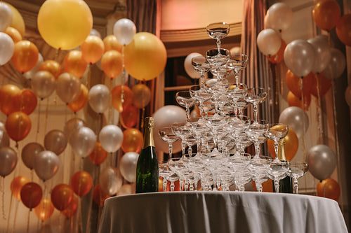 Pyramid of champagne glasses at party