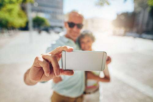 Happy senior couple on vacation taking a selfie