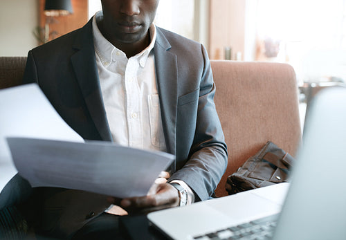 Businessman going through some documents at cafe