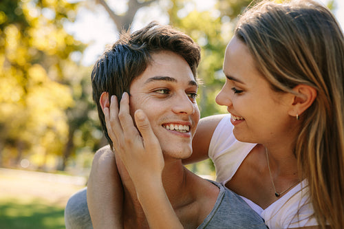 Close up of a happy couple in love standing in park