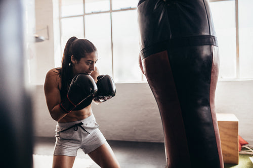 Female boxer training inside a boxing ring