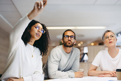 Smart businesswoman sharing her ideas with her team