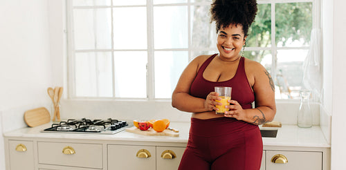 Plus size woman with glass of juice