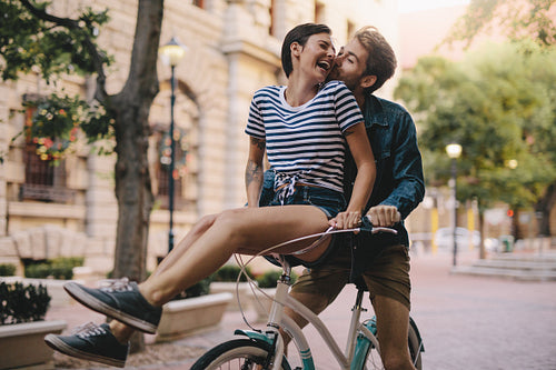 Couple having fun on a bicycle