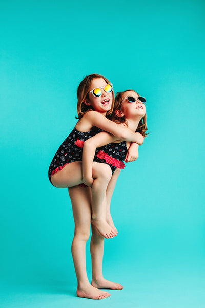 Girl in swimwear giving piggyback ride to her friend
