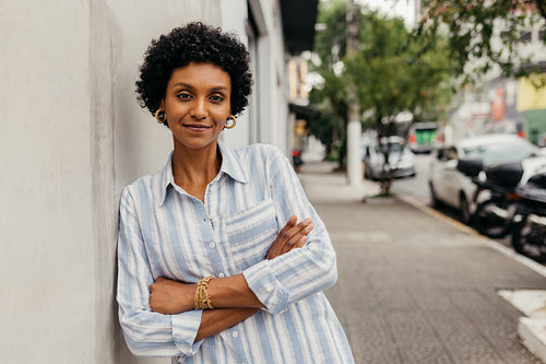 Happy young woman looking at the camera while standing outdoors