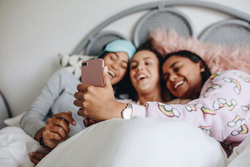 Three girl friends having fun during a sleepover