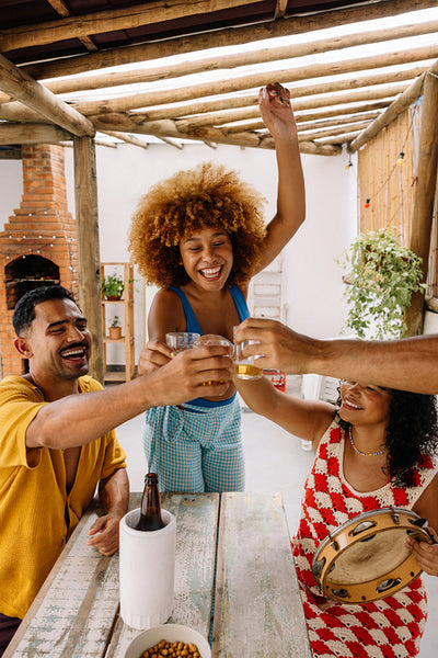 Friends celebrating with music and cheers at home in Rio de Janeiro
