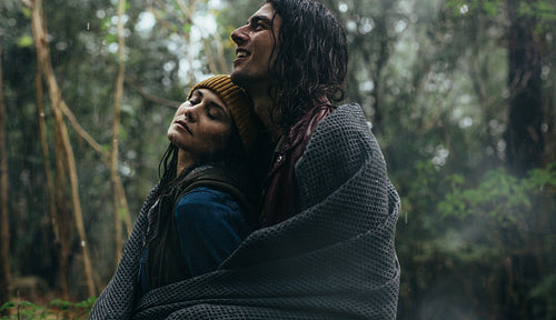 Romantic couple standing under the rain