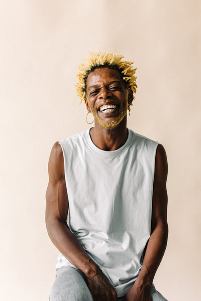 Smiling gay man sitting alone in a studio