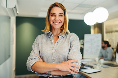Female manager smiling happily in a boardroom