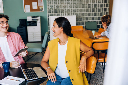 Young professionals enjoying a conversation in a modern office