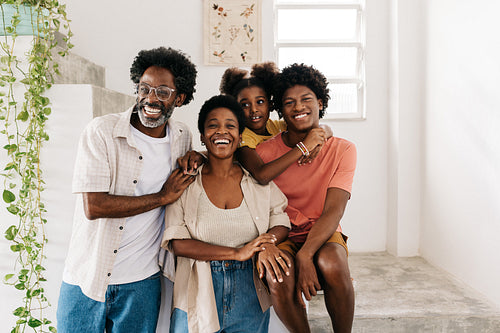 Happy Afro-Brazilian family smiling together at home