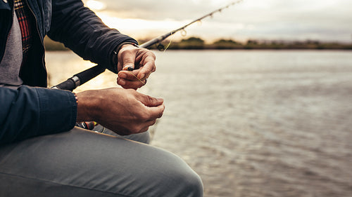 Person setting his fishing rod to catch fish