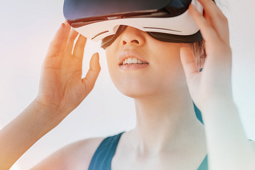 Woman using the virtual reality headset and looking away