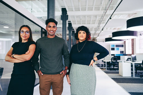 Three businesspeople standing together in an office