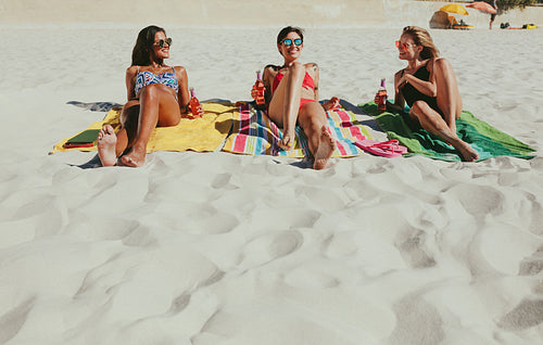 Girlfriends sunbathing on beach