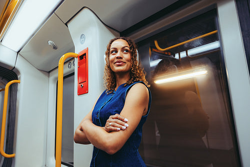 Thoughtful woman stands in the metro during city commute