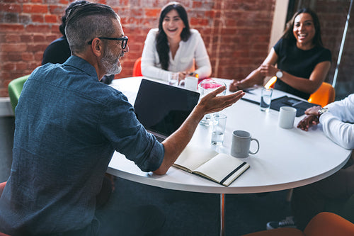 Mature businessman leading a meeting in a modern workplace