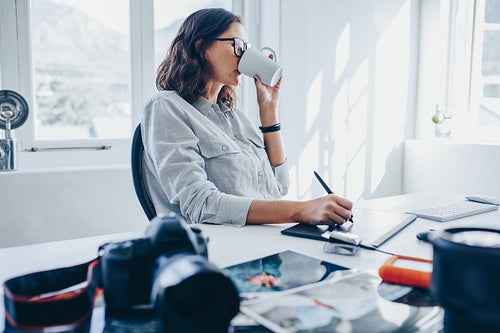 Woman editing images in office
