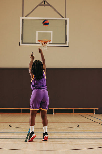 Aiming for greatness: Female player takes the shot at the hoop