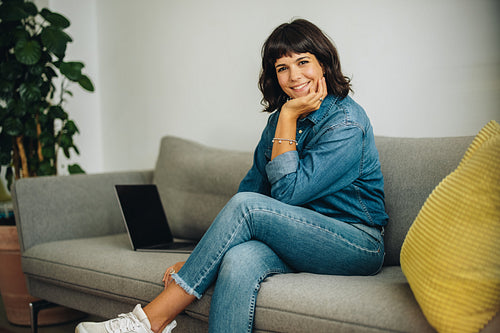 Confident female smiling at camera in office lobby
