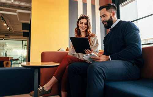 Happy businesspeople working together in an office lobby
