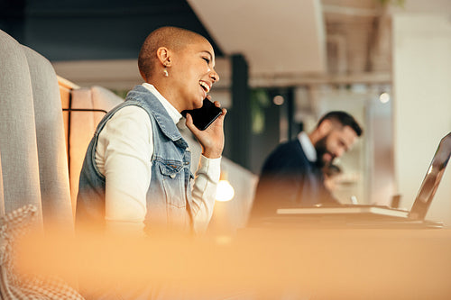 Modern buinesswoman speaking on the phone in a co-working space