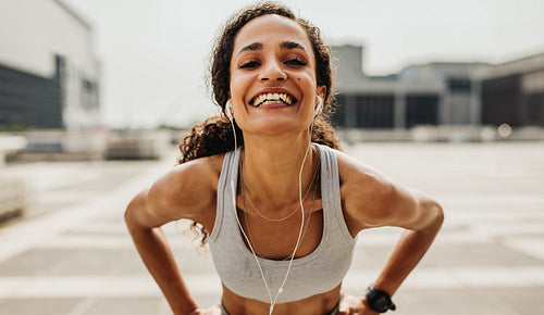 Cheerful female runner in the city