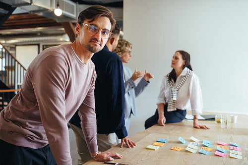 Business man having a meeting with his team in a marketing agency
