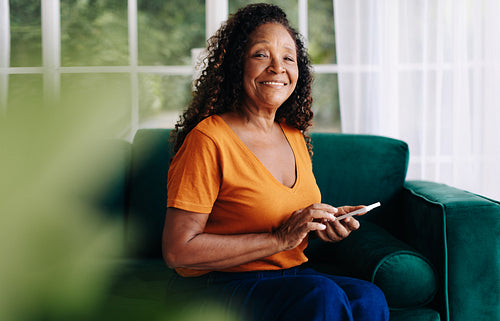 Portrait of a senior woman using mobile apps on her smartphone