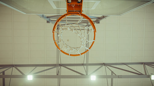 Basketball passes through the hoop net