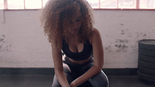 Fitness woman relaxing at gym after workout