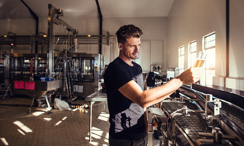 Brewery business owner testing the beer