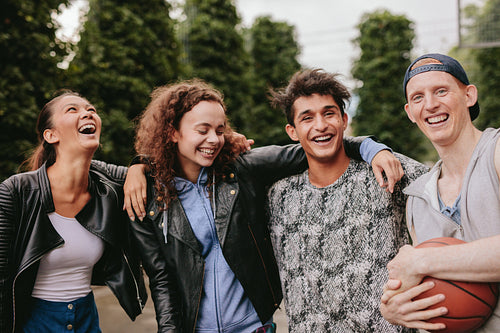 Four young friends smiling together