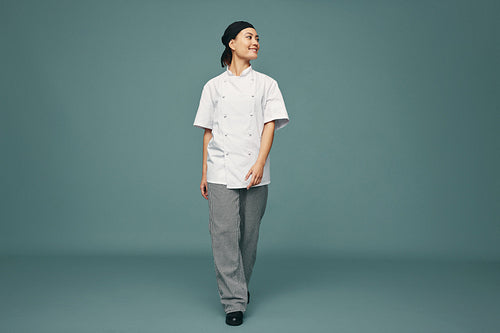 Happy kitchen chef walking in a studio